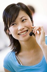 Woman wearing headset indoors smiling