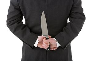 Businessman Holding Knife Behind His Back