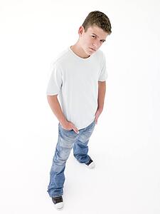 Teenage boy standing with hands in pockets