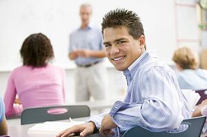 Male student with other students in classroom