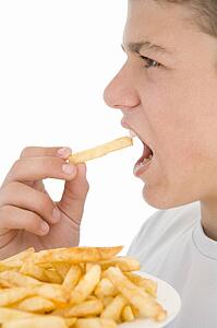 Boy eating French fries