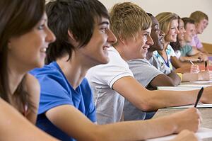 Students in class paying attention and taking notes (selective focus)