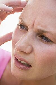 Head shot of woman scowling