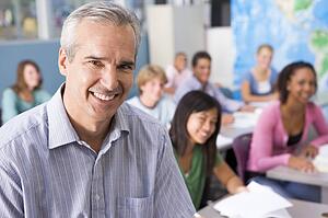Students studying in geography class with teacher