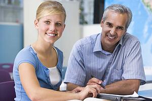 Teacher giving personal instruction to female student