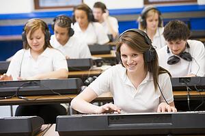 Students in music class working on keyboards