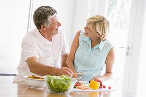 Husband And Wife Preparing meal, mealtime Together