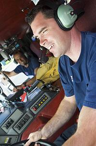 Two firemen in fire engine (selective focus)