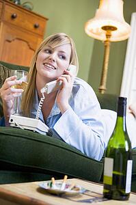 Young woman at home talking on telephone