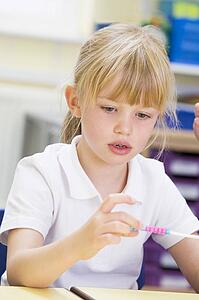Student in math class with counting beads