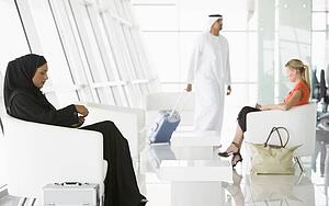 Airline passengers waiting in departure gate