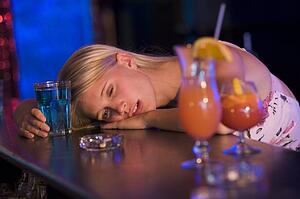 Drunk young woman passed out in bar