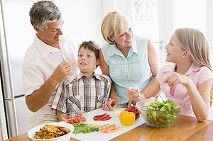 Grandparents And Grandchildren Prepare A meal, mealtime Together 