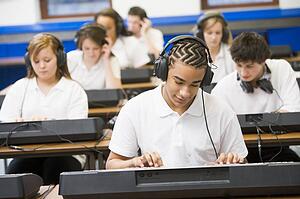 Students in music class working on keyboards