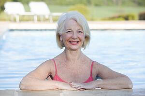 Woman in outdoor pool smiling
