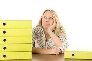 Businesswoman With Stack Of Folders