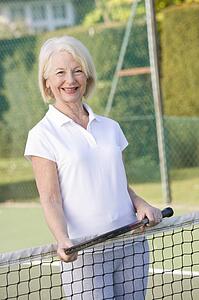 Woman playing tennis and smiling