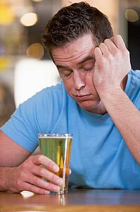 Innebriated man with glass of beer