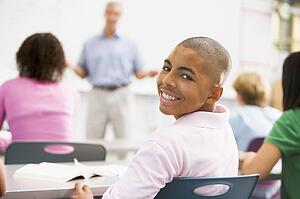 Male student with other students in classroom