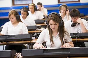 Students in music class working on keyboards