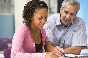 Teacher giving personal instruction to female student