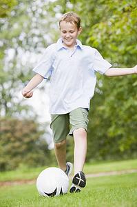 Young boy playing soccer