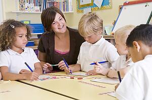 Students and teacher in math class with counting beads