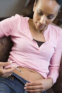 Woman injecting drugs to prepare for IVF treatment