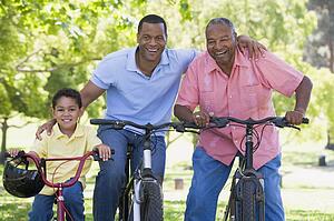 Grandfather grandson and son bike riding.