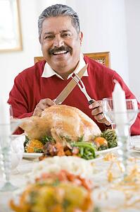 Senior Man Excitedly Getting Ready To Carve The Turkey