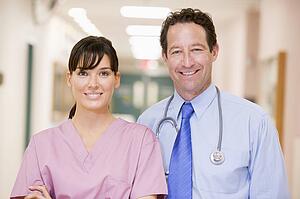 Doctor And Nurse Standing In A Hospital Corridor