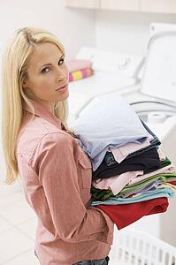 Woman Carrying Folded Up Laundry