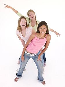 Three girl friends in a row smiling