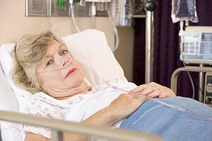 Senior Woman Sleeping In Hospital Bed