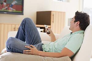 Man in living room watching television
