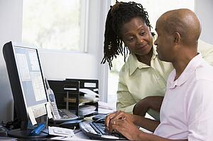 Couple in home office using computer
