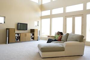 Couple in living room watching television
