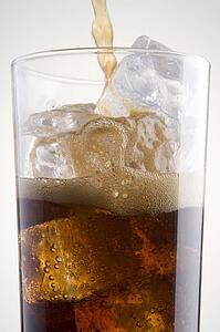 Pouring Cola Into A Glass Of Ice