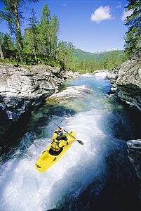 Kayaker rowing in rapids