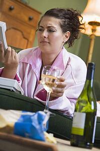 Annoyed young woman looking at telephone handset