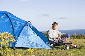 Man camping outdoors and cooking