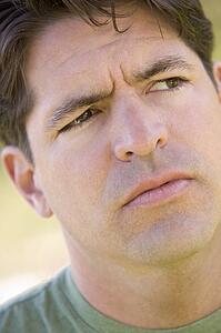 Head shot of man scowling