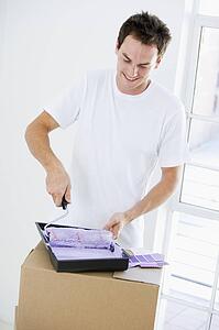 Man painting room in new home smiling