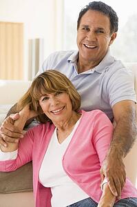Couple relaxing in living room and smiling