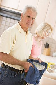 Husband And Wife Cleaning Dishes