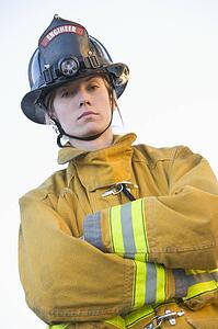 Firewoman standing outdoors wearing helmet