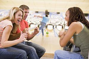 Man bowling with friends