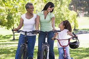 Grandmother mother and granddaughter bike riding.