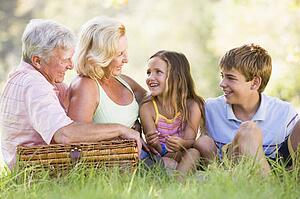 Grandparents having a picnic with grandchildren.