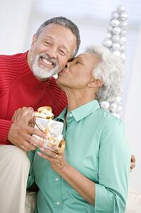 Senior Couple Exchanging A Christmas Gift